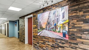 A hallway with a wooden wall and a large mural of a street scene.