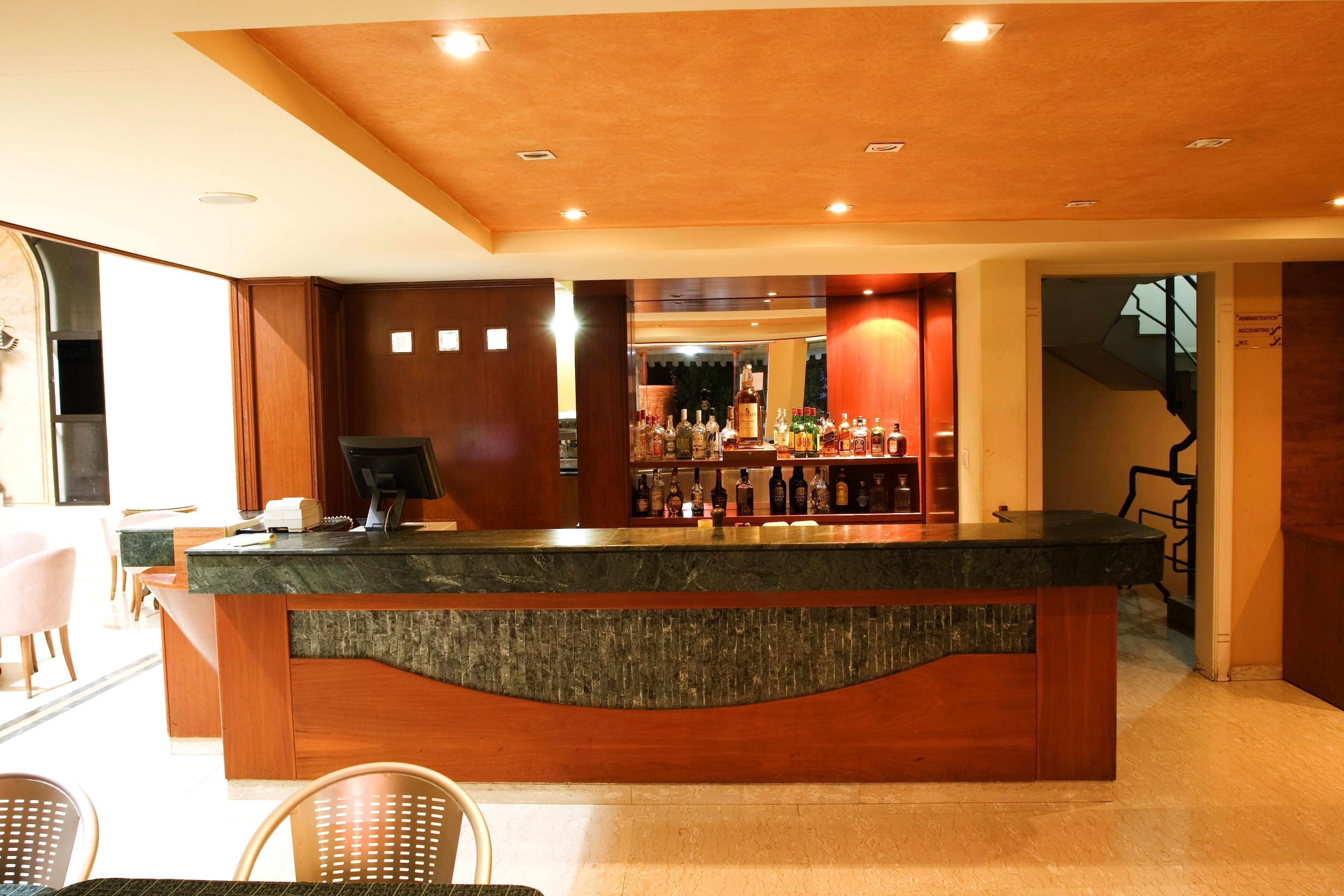 A bar area with a wooden counter and seating.