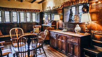 A traditional kitchen with wooden furniture, a central island, and a window with a view.