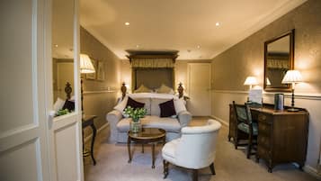 A bedroom with a bed, a desk, a chair, a dresser, and a mirror.
