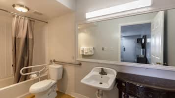 A bathroom with a toilet, sink, and shower.