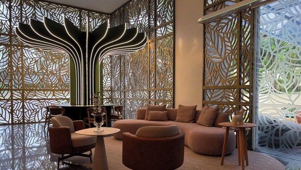 A modern interior with a seating area, a table, and decorative panels.