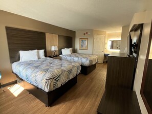 A hotel room with two beds, a desk, a mirror, and a small kitchenette. - Motel 6 Georgetown, SC - Marina (Georgetown)