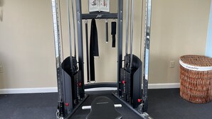 A home gym with a Smith machine, a bench, and a pull-up bar. - Baymont by Wyndham Thomasville (Thomasville)