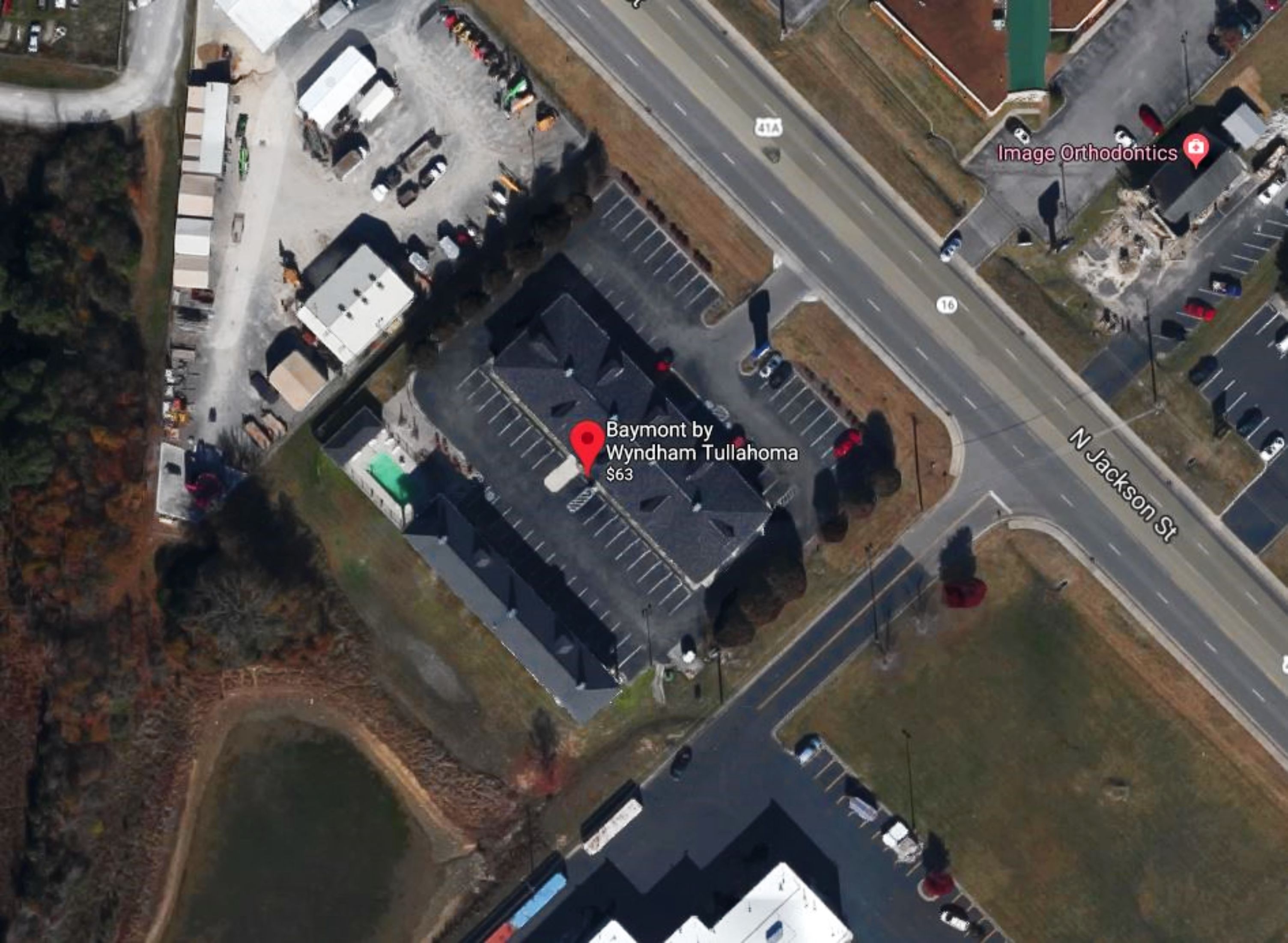 An aerial view of a building with a parking lot, labeled 'Baymont by Wyndham Tullahoma' with a price tag of $63.