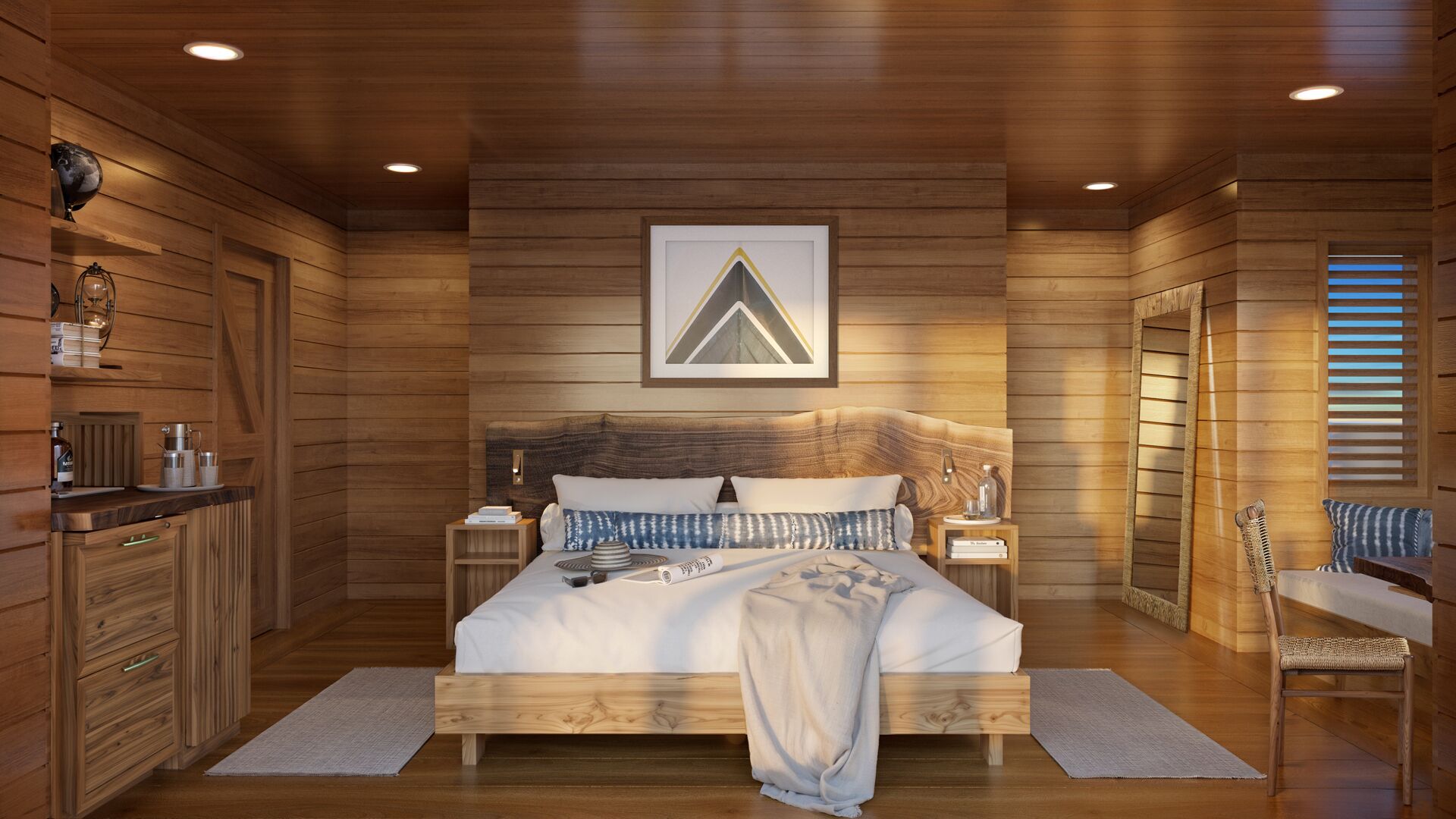 Ein schlichtes Schlafzimmer im Blockhausstil mit einem Bett, Nachttischen, einem Sessel und einem gerahmten Bild an der Wand.