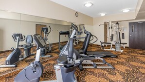 A gym with various exercise equipment, including treadmills, stationary bikes, and weight machines. - Best Western Northwest Inn (Dallas)