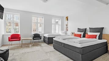 Hypo-allergenic bedding, desk, laptop workspace, blackout drapes
