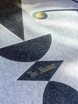 A floor with a geometric pattern and the text 'The Manhattan' visible. - The Manner, The Unbound Collection by Hyatt (New York)