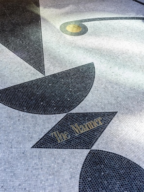 A floor with a geometric pattern and the text 'The Manhattan' visible.
