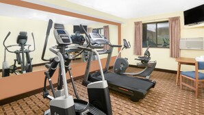 A hotel gym with treadmills, elliptical machines, and a mirrored wall. - Super 8 by Wyndham Boone (Boone)