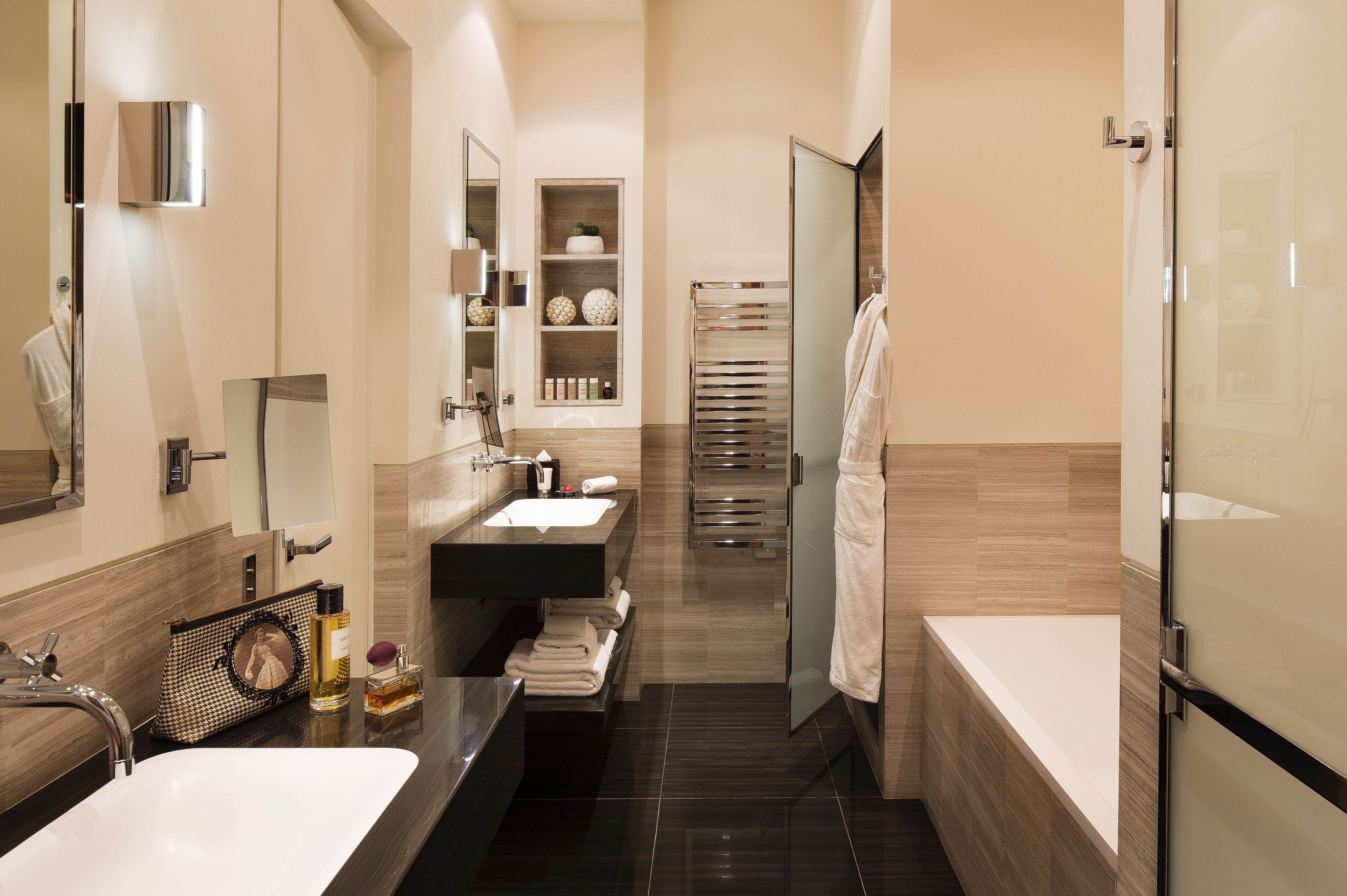 A modern bathroom with a large bathtub, a separate shower area, and a vanity with a mirror.