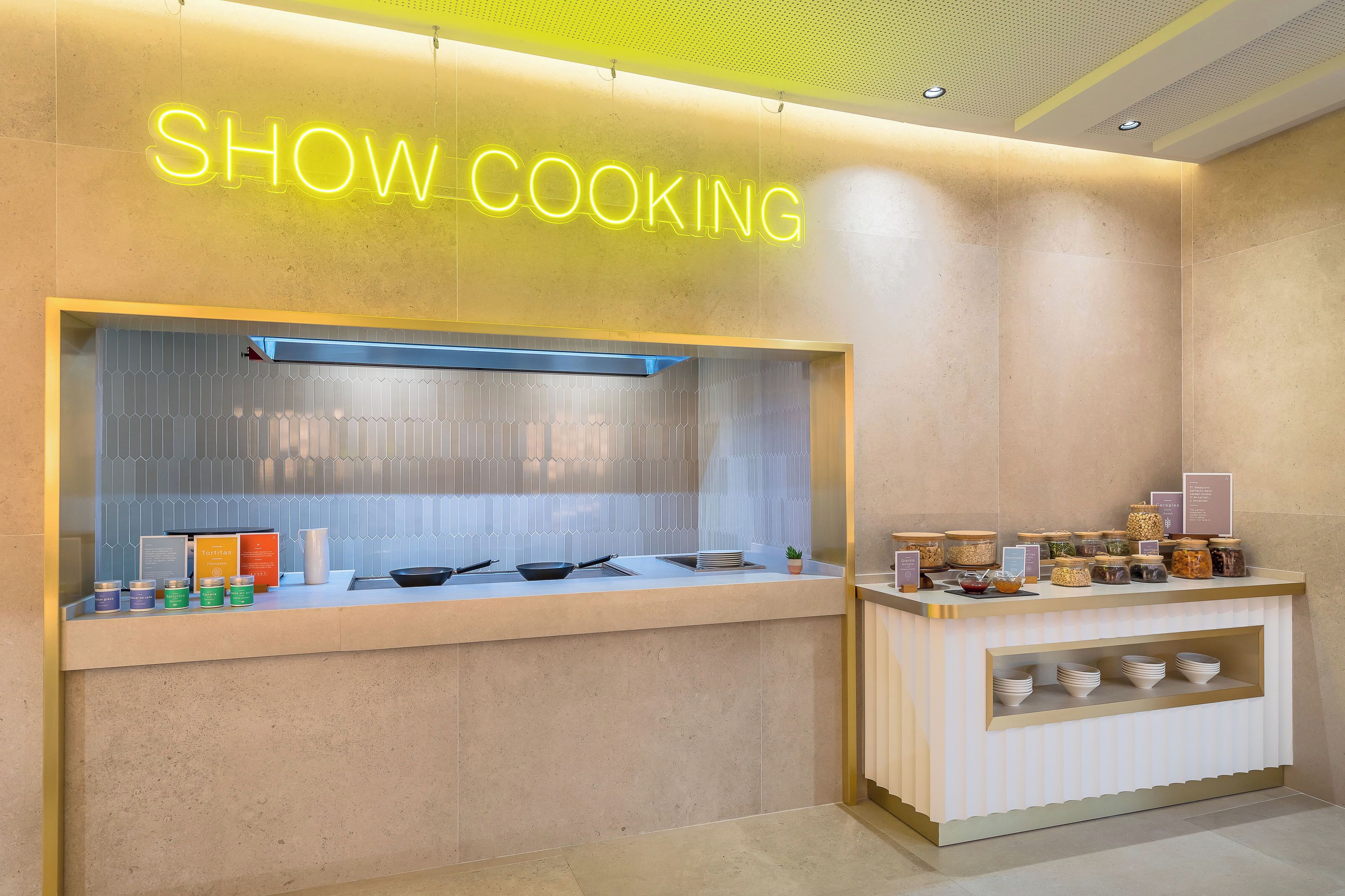 A kitchen area with a neon sign reading "SHOW COOKING".