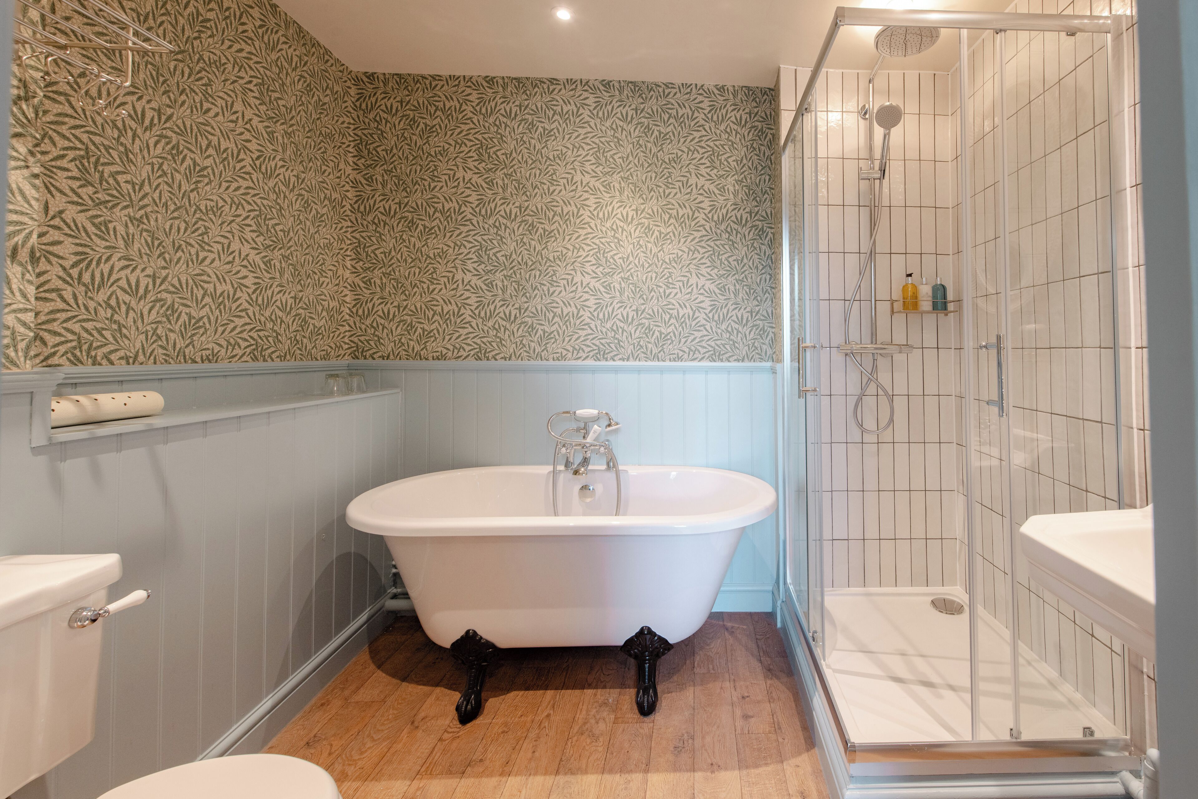 A bathroom with a freestanding bathtub, a shower enclosure, and a toilet.