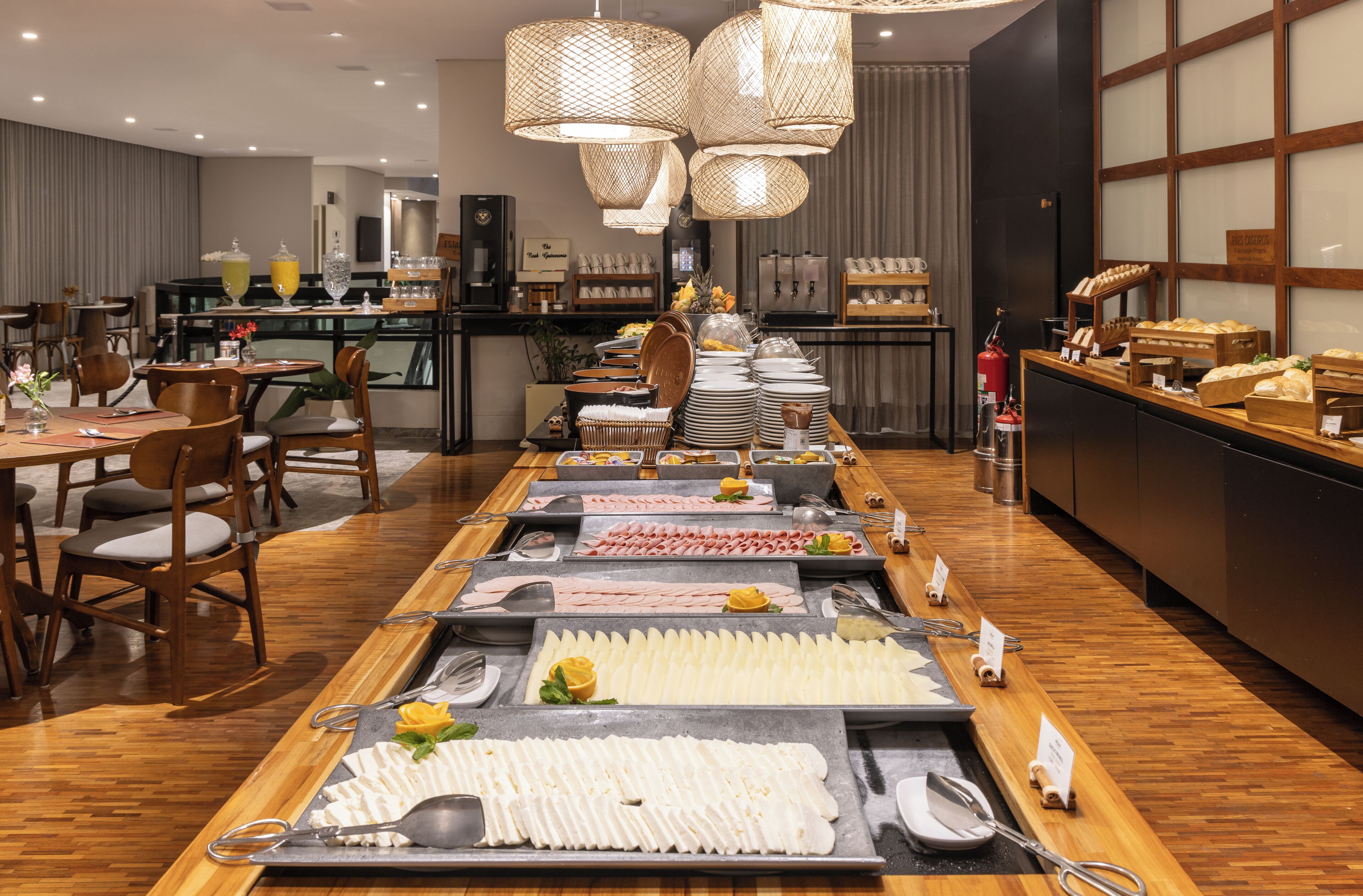 A buffet setup with various food items and utensils.