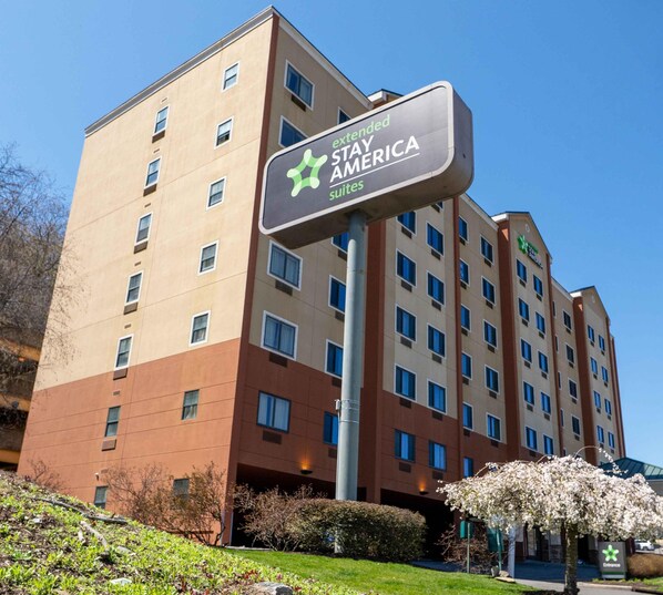 A Stay America hotel with a modern design, featuring multiple floors and a prominent signage.