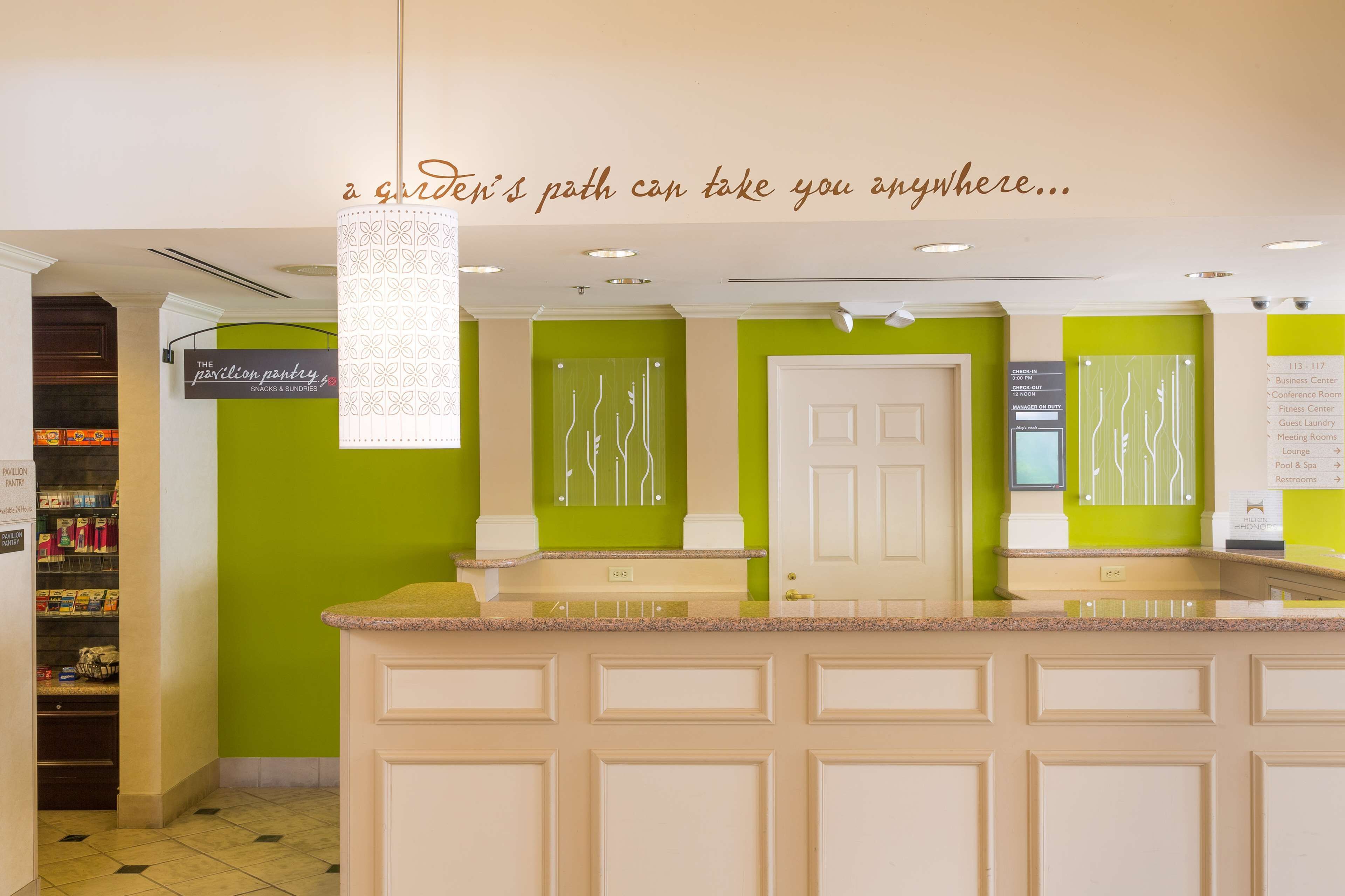 A reception area with a counter, a sign for the pastry shop, and a door to the conference room.