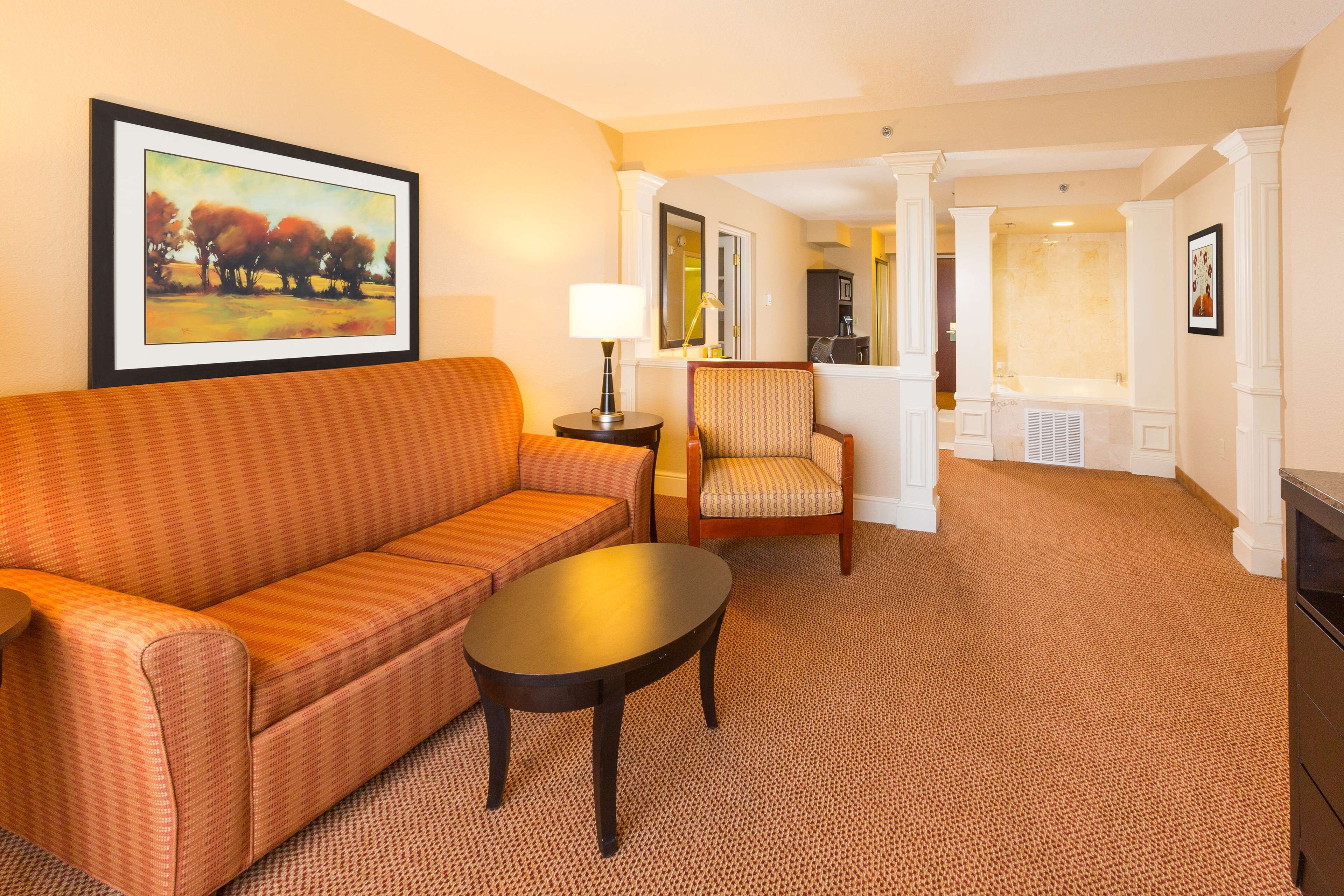 suite, 1 bedroom, jetted tub | living area | tv, video game console, pay films, mp3 dock