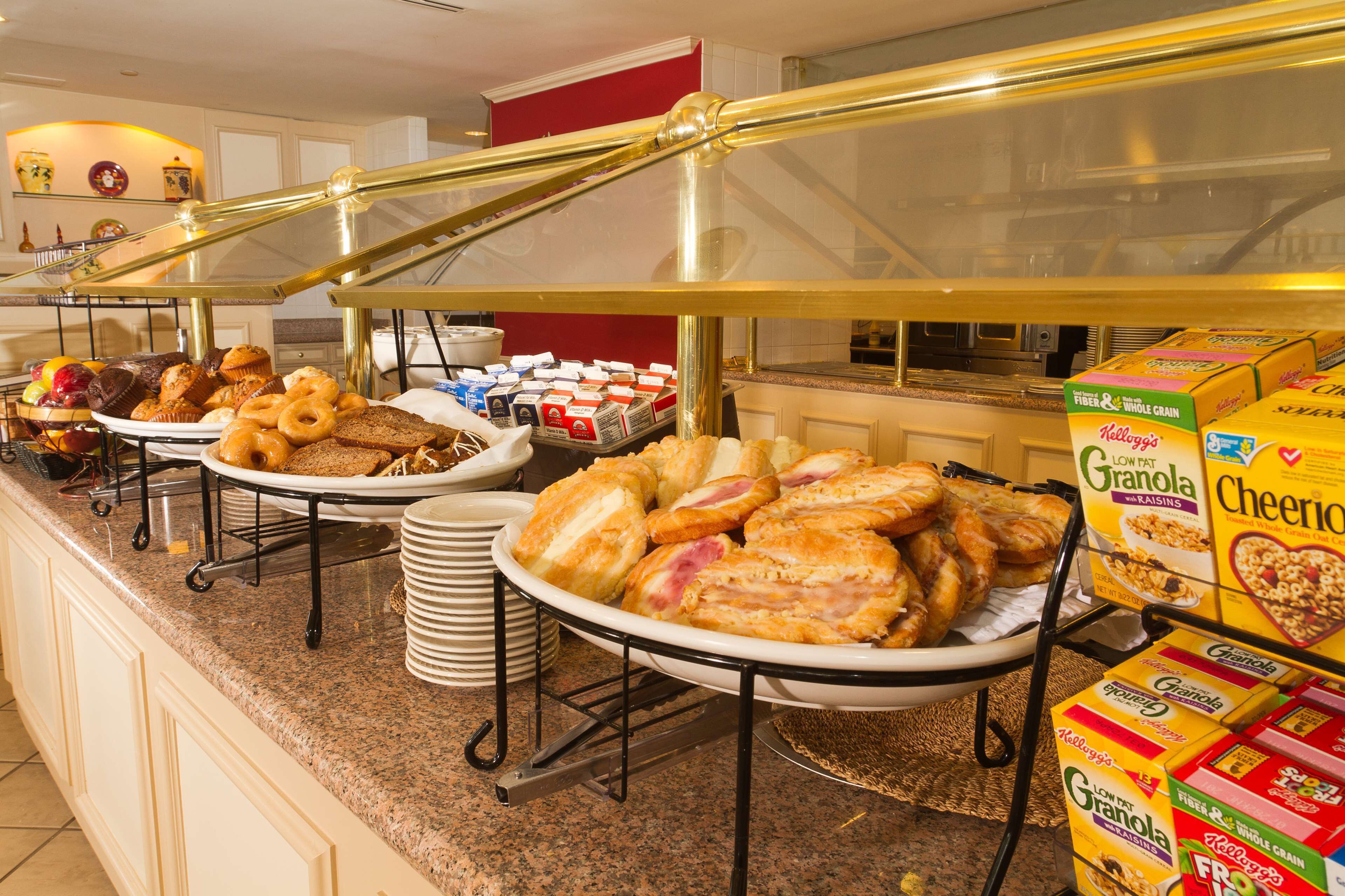 A buffet with various food items and breakfast cereals.