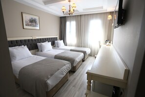 A hotel room with two beds, a large mirror, and a chandelier. - Albatros Premier Hotel - Special Class (Istanbul)