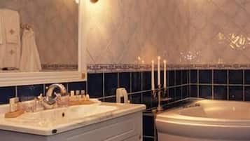 A bathroom with a bathtub, a sink, and a mirror.