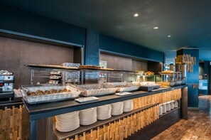 A buffet setup with various food items and a coffee machine. - Eurostars Marivent Hotel (Palma de Mallorca)