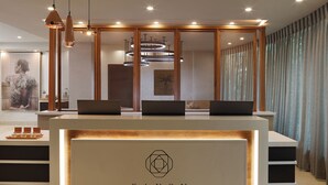 A reception desk with a modern design, featuring a logo and the name "SAXON SPA".