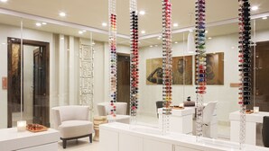 A modern spa with a large mirror, a reception desk, and a seating area.