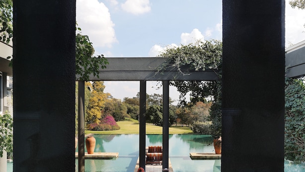 A view of a pool area with lounge chairs and a pergola structure. - Saxon Hotel, Villas and Spa (Sandton)