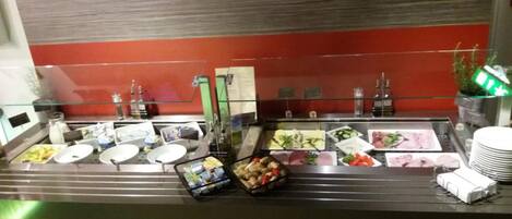 Een buffetgedeelte met verschillende gerechten en toevoegingen.