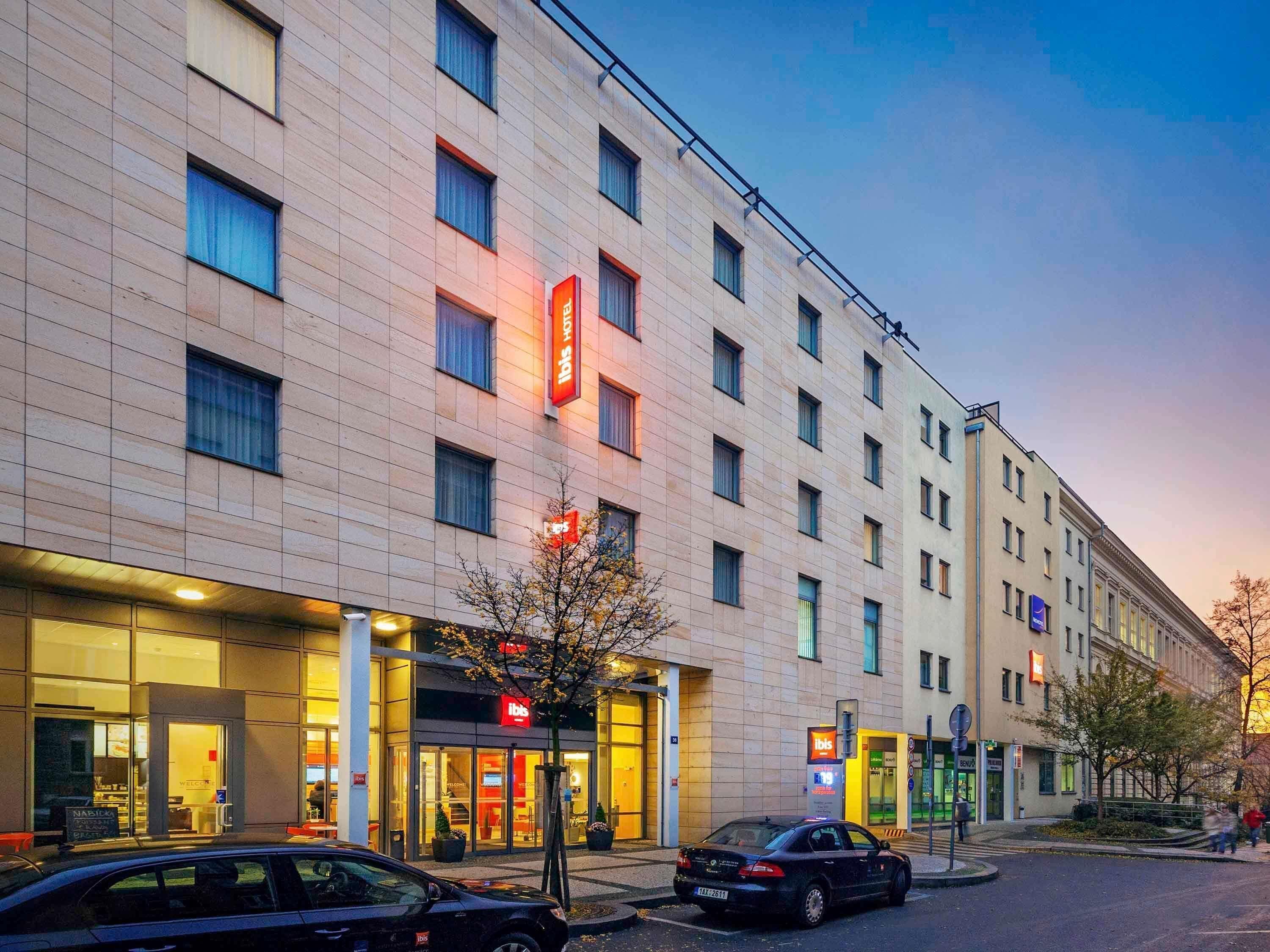 A hotel with a modern facade, multiple windows, and a visible entrance.