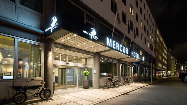The exterior of the Mercuri Hotel with a modern facade, large glass windows, and a prominent entrance. - ProfilHotels Mercur (Copenhagen)