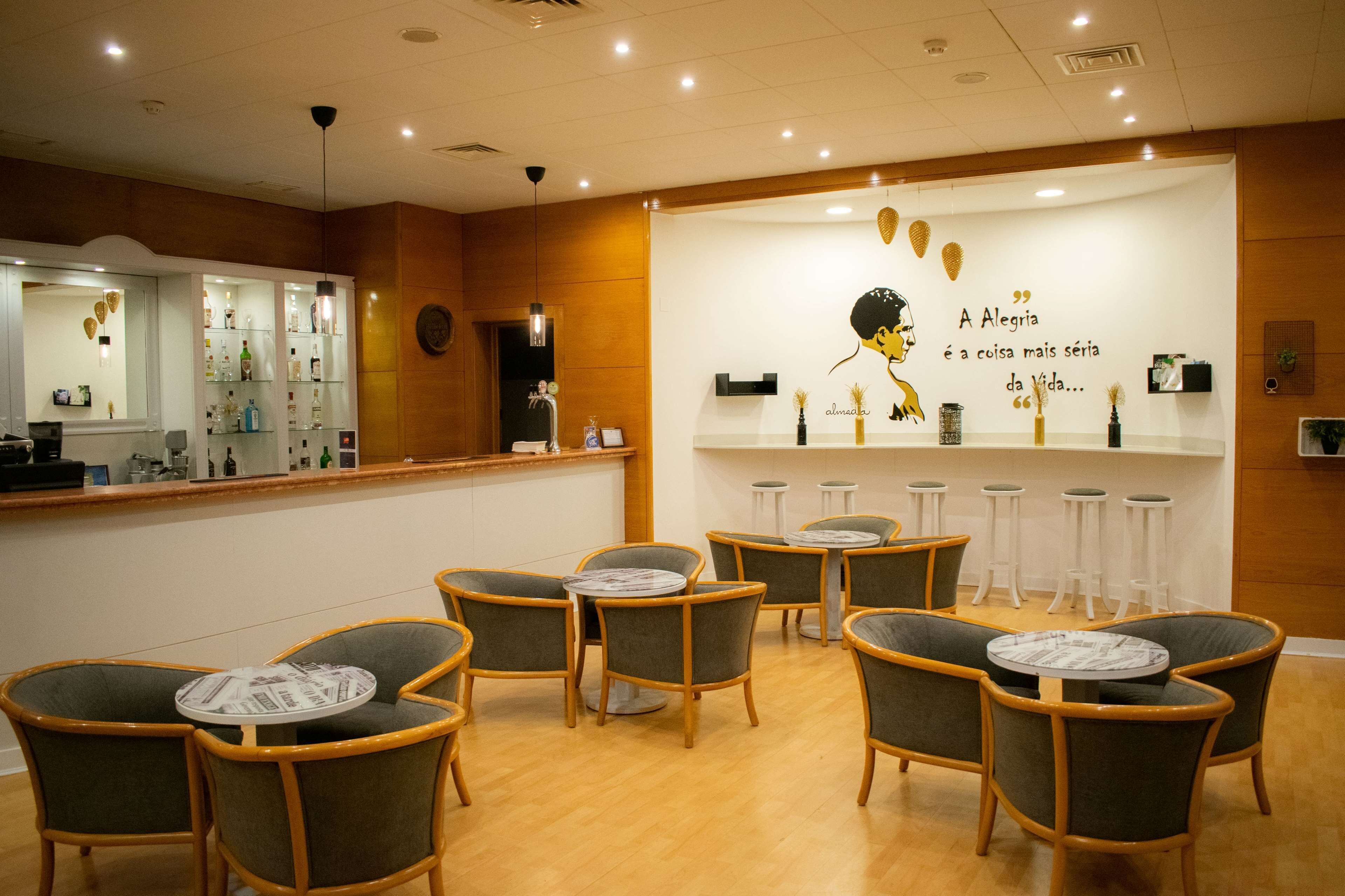 A reception area with a counter, chairs, and a wall with a quote.