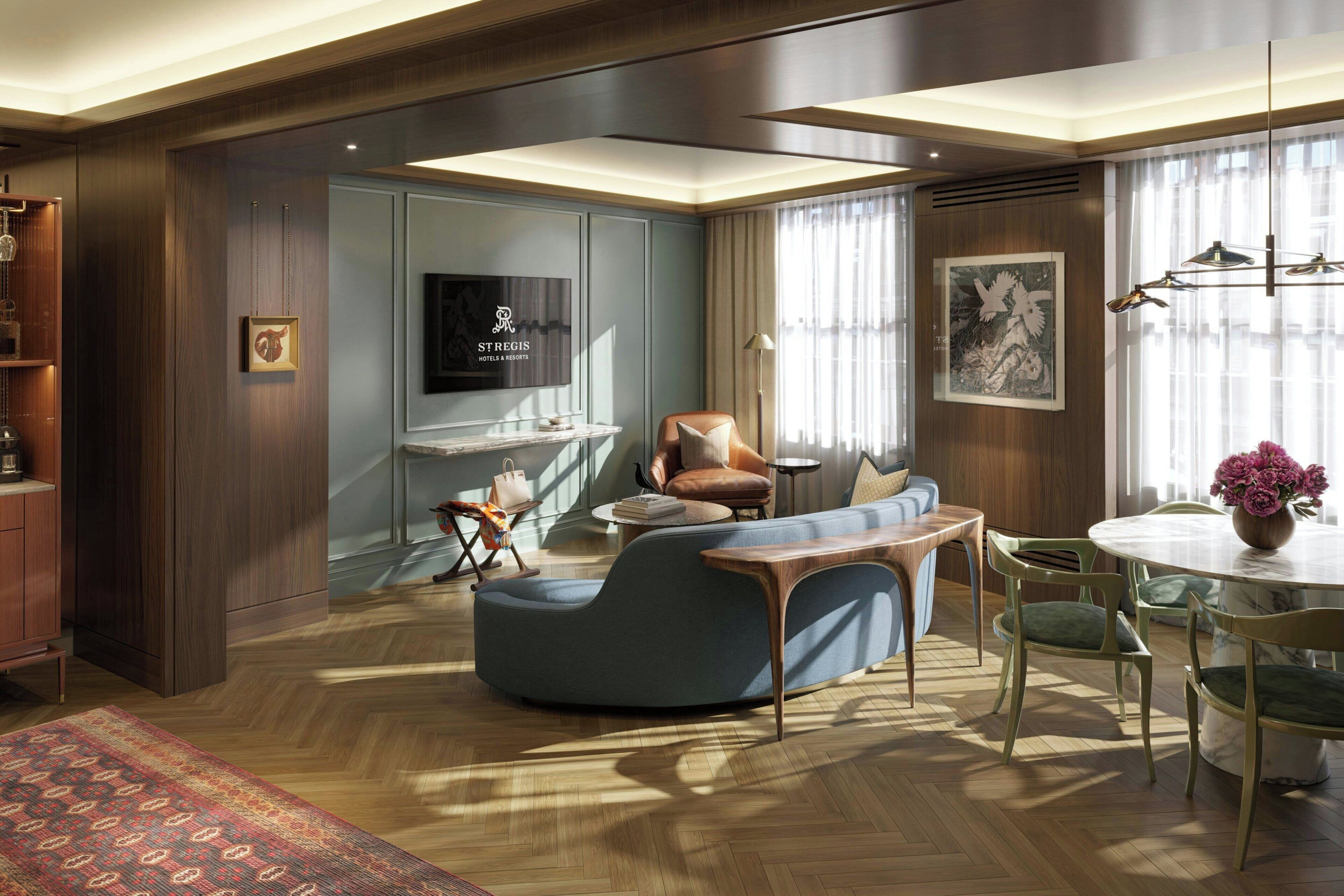 A modern living room with a sofa, armchair, and dining table.