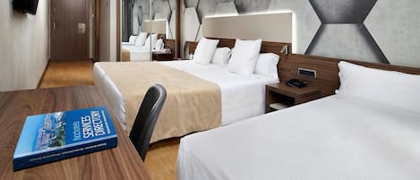 A hotel room with two beds, a wooden desk, a book titled 'Hotel Services Directory', and a modern geometric wall design.