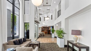 A spacious lobby with a reception desk, seating area, and large windows. - Parkside Hotel & Apartments Auckland (Auckland)