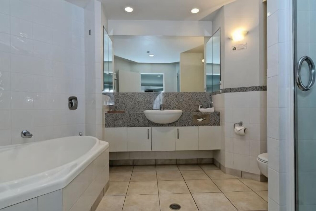 A bathroom with a bathtub, a sink, a toilet, and a shower.
