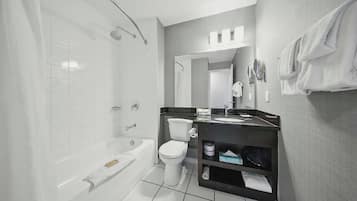 A modern bathroom with a bathtub, toilet, and sink.