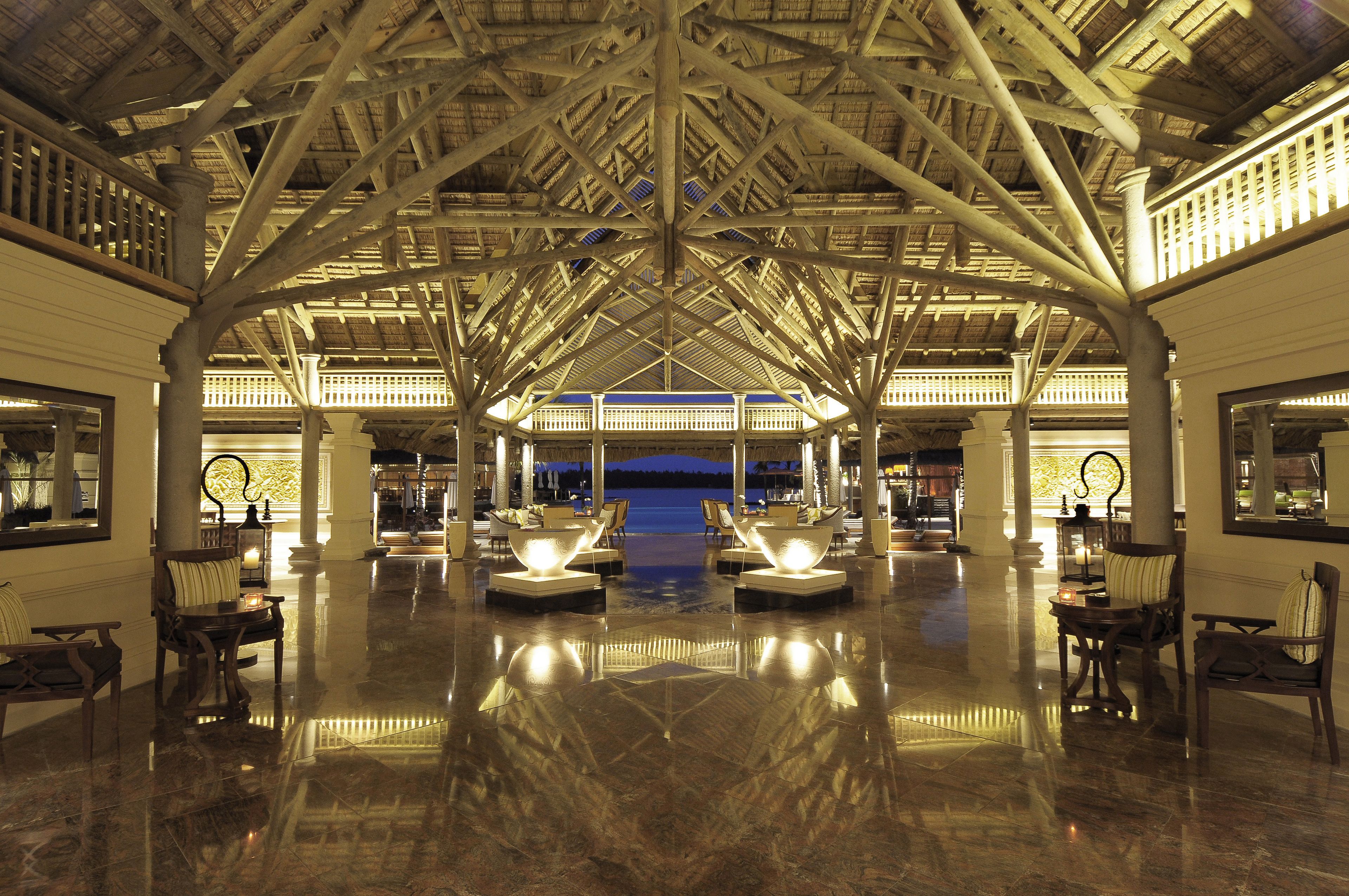 A spacious lobby with a high ceiling and a central seating area.
