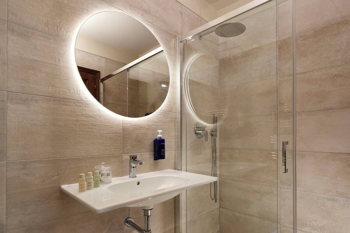 combined shower/bathtub, designer toiletries, hair dryer, bathrobes