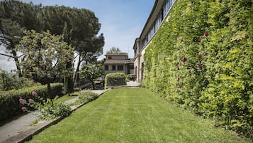 A well-maintained garden with a pathway leading to a building.