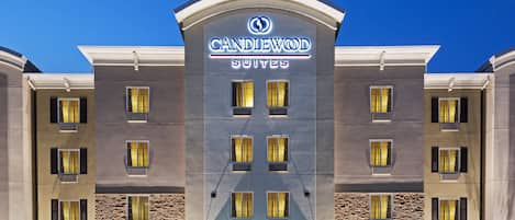A hotel with a modern facade, multiple windows, and a prominent entrance.