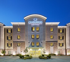 A hotel with a modern facade, multiple windows, and a prominent entrance.