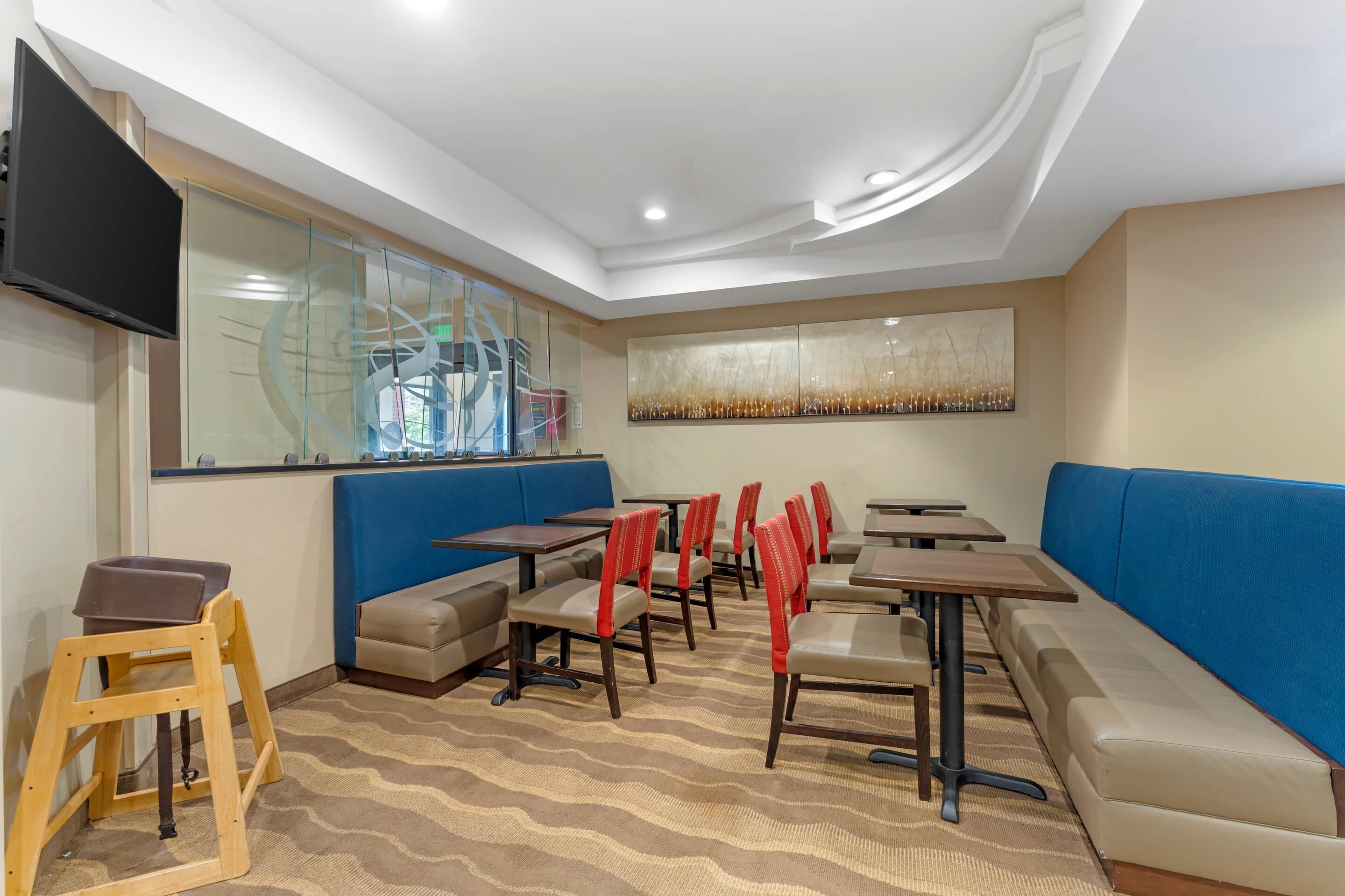 Un restaurante con mesas, sillas y cabinas.