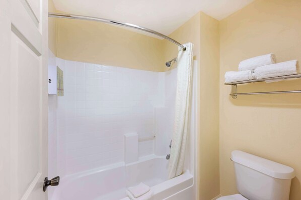 A bathroom with a bathtub, toilet, and a towel rack. - Best Western Snyder Inn (Snyder)