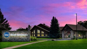 A Best Western hotel with a stone facade, large windows, and a well-maintained lawn.