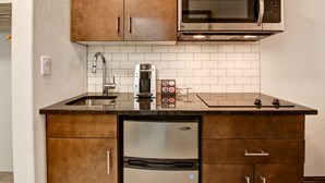 A kitchen with a stainless steel microwave, a coffee maker, and a dishwasher. - Canalta Hotel Hanna (Hanna)
