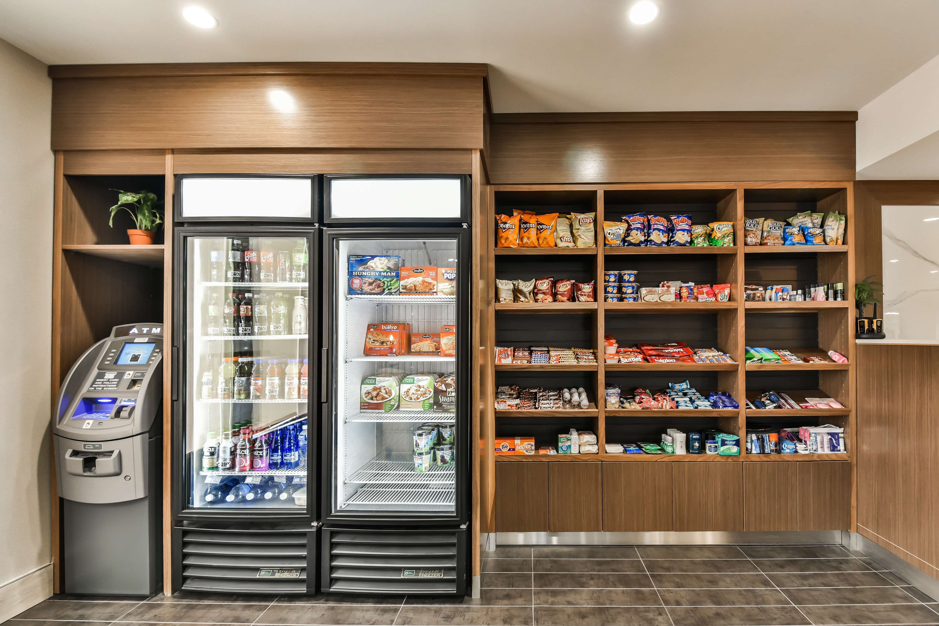 A self-service kiosk with a refrigerated display and a variety of snacks and beverages.