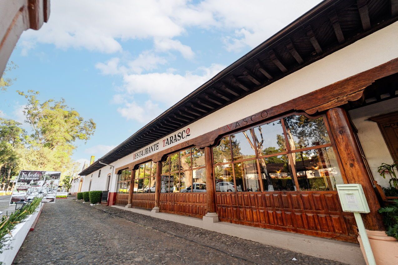 A restaurant with a wooden facade and large windows.