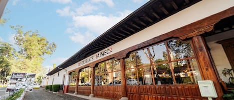 A restaurant with a wooden facade and large windows.